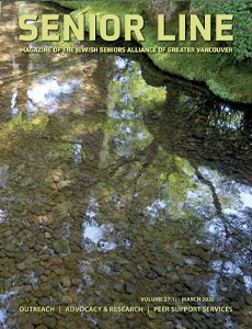 A tree is reflected in the water of a stream.