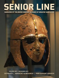 A bronze helmet with gold trim on display.