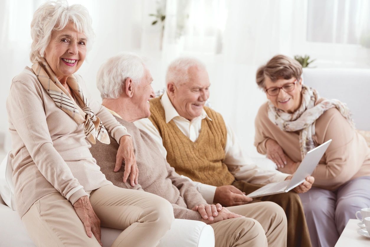 A group of people sitting around each other.