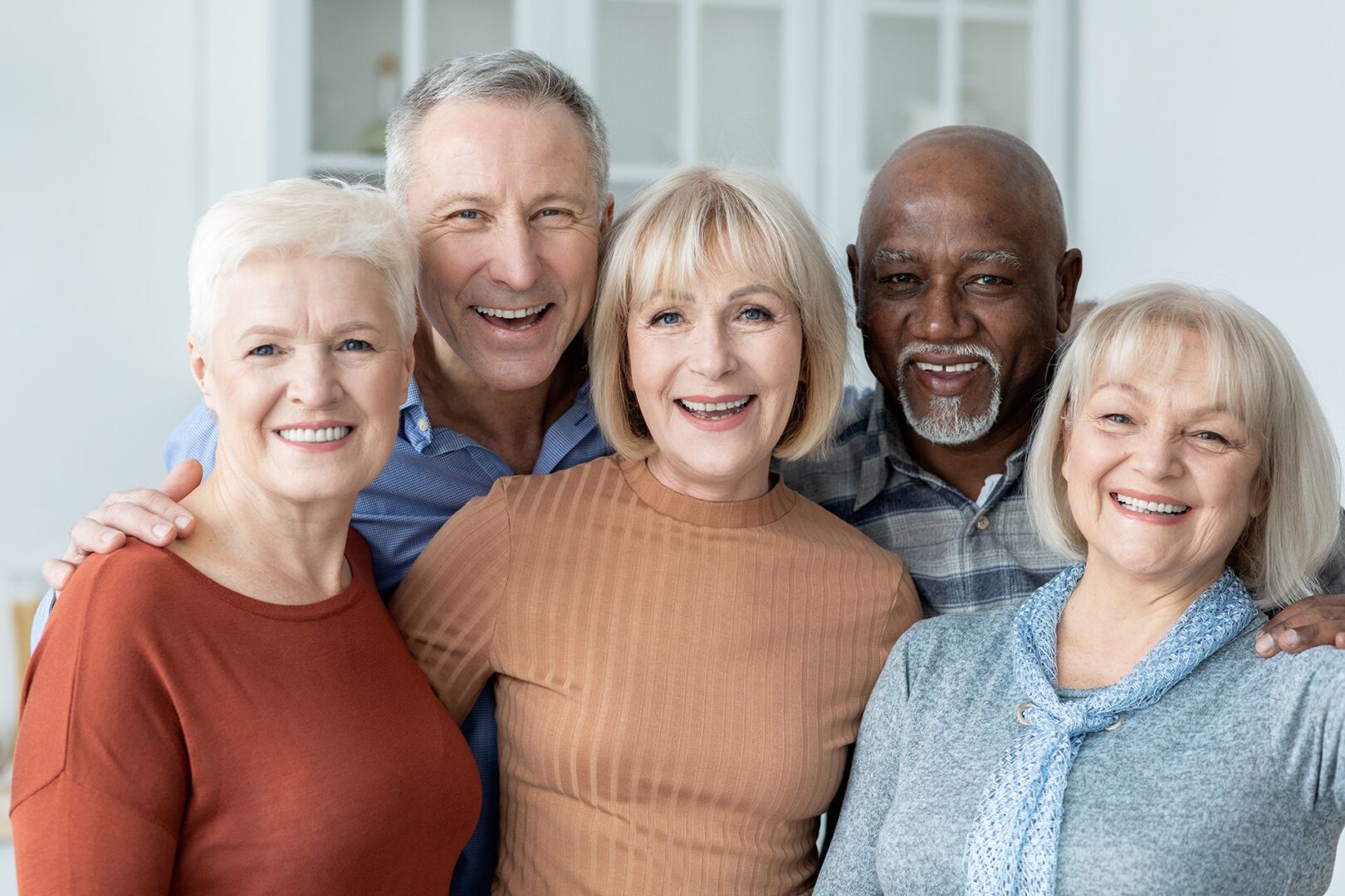 A group of people standing together smiling for the camera